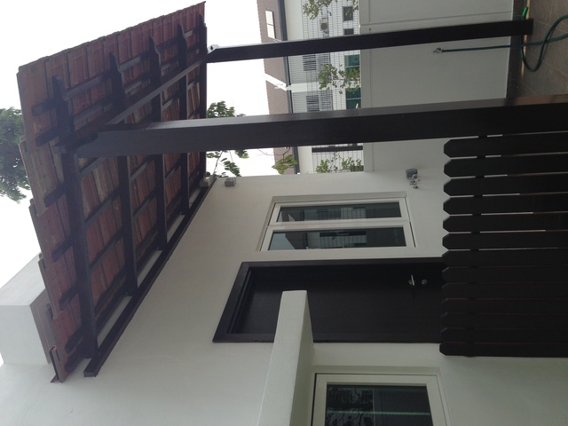 Explore CTE IDEA SDN BHD's deftly designed outdoor space, as seen in their 'Main Services' portfolio. This snapshot showcases their expertise in Malaysian home exteriors, featuring a sleek white facade paired with wooden accents, modern windows, and structured elements that offer both form and function, blending aesthetic appeal with practicality—a testament to their innovative architectural mastery.