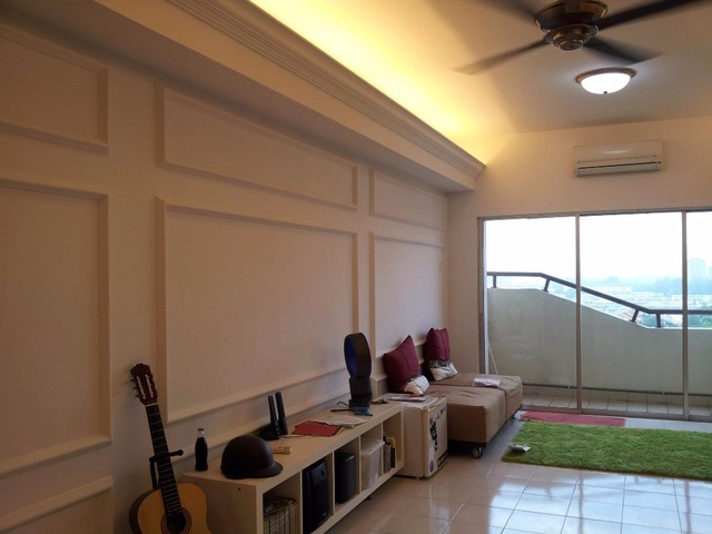 This elegant living room designed by ICONFACTORY SDN BHD showcases a minimalist aesthetic from the Megaria Tulip Apartment in Bukit Serdang. The neutral palette is accented by rich maroon cushions, complementing the warm, earthy tones of the wood furniture. Natural light floods in from the balcony, casting a serene glow on the clean lines and tailored wall paneling that exudes modern sophistication ideal for contemporary Malaysian home interiors.