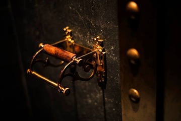 This image showcases a detailed close-up of a steampunk-inspired toilet paper holder from BANGKU STORE's HUGO STEAMPUNK PREMIUM LOUNGE. The striking antique brass finish and mechanical design elements echo Malaysia’s first bar and lounge with a steampunk theme, reminiscent of a classical railway station. The warm, ambient lighting highlights the retro-industrial aesthetic, reflecting the venue's visual feast that blends steam-powered heritage with a futuristic twist. Ideal for those enchanted by a pseudo-Victorian, technofantasy decor.