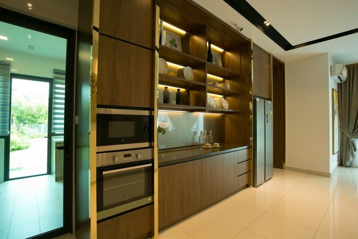 Modern kitchen design by Nice Style Interior Design at Setia Eco Glades, Cyberjaya, featuring warm wood panels with integrated lighting, sleek built-in stainless steel appliances, and a bright, spacious atmosphere that encapsulates the contemporary, modern ethos from their Semi-D House at Ludwigia portfolio.