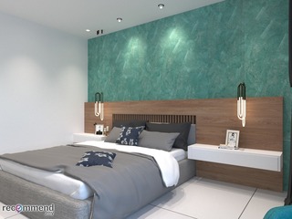 This modern bedroom designed by R Works, from their RIMBAYU portfolio, showcases a contemporary style with a soothing color palette. The room features a large comfortable bed with navy blue accents, sleek wooden headboard, unique pendant lights, and a striking teal feature wall which adds a vibrant touch to the otherwise neutral tones. Perfect for those seeking stylish and serene bedroom interior design inspiration in Malaysia.