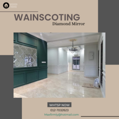Elegant interior showcasing BEZCHO DECOR KUANTAN's craftsmanship in a room with polished marble flooring that gleams under stylish lighting. The space features sophisticated dark green Nyatoh wood wainscoting, complemented by a large diamond-shaped mirror that enhances the luxurious feel. This expert design is an example of the Wainscoting theme, reflecting upscale taste and Malaysian interior design trends, perfect for those seeking inspiration for their home decor with a touch of classic woodwork elegance.